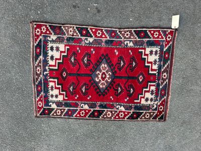 a close up of a red and blue rug on the ground