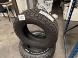 two tires are stacked on top of each other in a warehouse