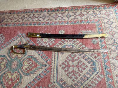 two swords that are on a rug on the floor