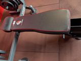 the gym equipment is sitting on the floor next to a red wall