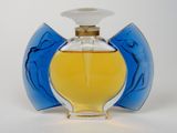 a bottle of perfume sitting on a white surface