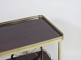 a small metal table with a glass top on a white background