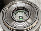 a close up of a camera lens with a box in the background