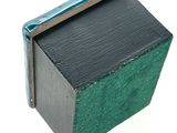 a small black and green box with a blue handle
