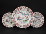 three chinese plates with flowers and birds on them on a black background