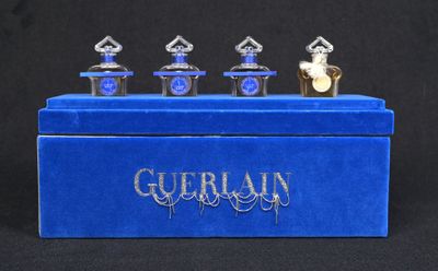 a close up of a blue box with three perfume bottles on it