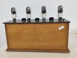 an image of a wooden box with four vacuums on top of it