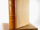 an image of a brown book sitting on top of a wooden block