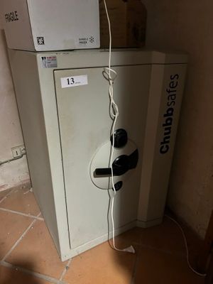 a small refrigerator with a microwave on top of it