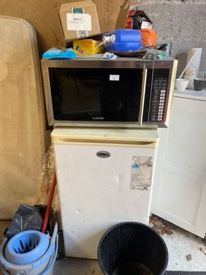 an image of a kitchen with a microwave and a trash can