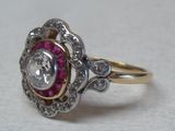 an image of a diamond and ruby ring on a table