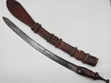 a pair of old swords with wooden handles on a white surface