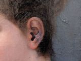portrait of a young girl with a cat ' s ear in her left ear