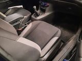 the interior of a blue car with a steering wheel and dashboard