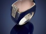 a close up of a ring with a pink stone and diamonds