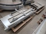 several pieces of metal are sitting on pallets in a warehouse