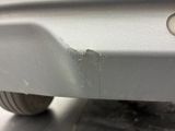 a close up of a car ' s bumper with a small hole in it