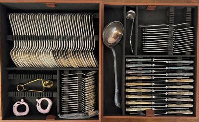 a drawer full of silverware and a pair of scissors
