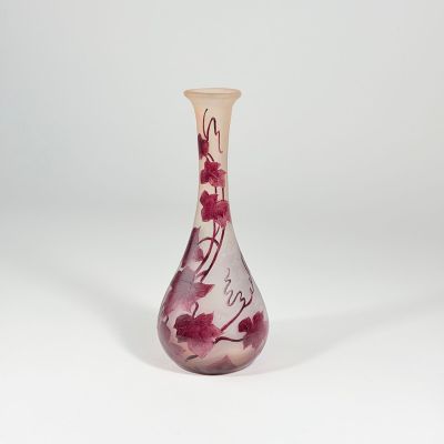 a glass vase with a red and white design on it