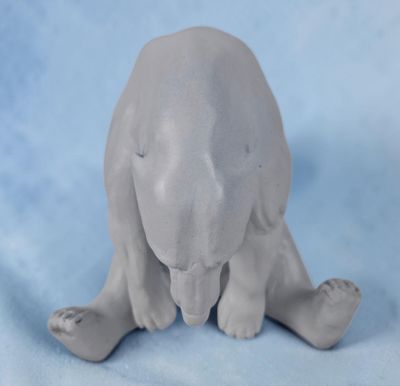une sculpture représentant un ours polaire assis sur une surface bleue
