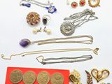 many different types of jewelry on a white surface