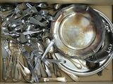 a box full of silverware and silver spoons in it