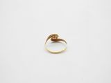 a close up of a gold ring on a white surface