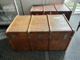 three trunks stacked on top of each other in a room