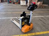 a forklift that is sitting in the middle of a parking lot