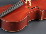 an old violin sitting on top of a table with a bow on top of it