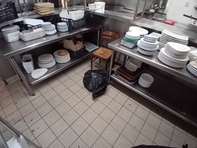 a kitchen with a lot of plates and bowls on the counter