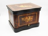 a small wooden box with a floral design on it