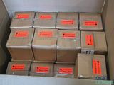 a box full of boxes with orange labels on them
