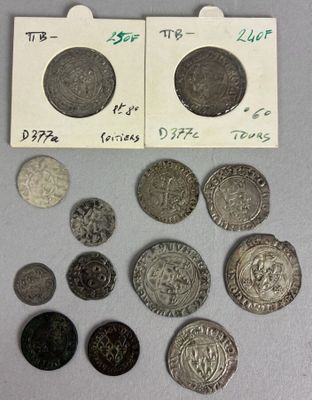some coins are sitting on top of a table next to a piece of paper