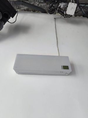 a white electronic device sitting on a table next to a bike