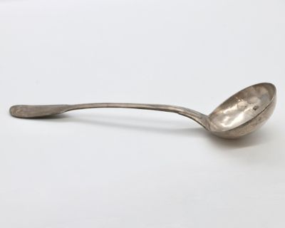 a close up of a spoon on a white surface with a white background