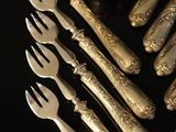 a lot of silver spoons and forks on the table