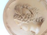 a picture of a sculpture of a woman with a wreath on her head