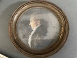 a picture of a man in a suit and tie in a gold frame