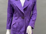 a mannequin wearing a purple blazer and black leggings