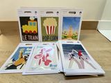 four postcards are sitting on a table next to each other