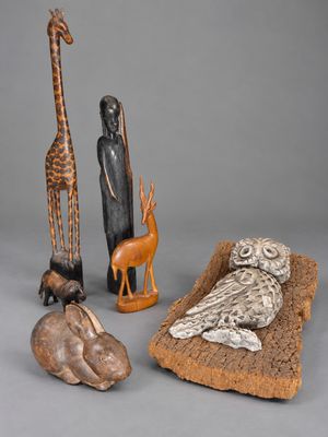 several different types of african figurines including a giraffe, an owl, and a bird