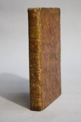 an old book sitting on top of a table next to a white background
