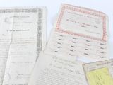 some old papers are sitting on top of a white table