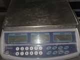 a digital scale sitting on top of a metal counter