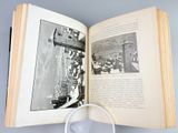 an open book with a magnifying glass on top of it