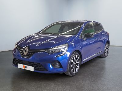 a blue car is parked in a large room with a black floor