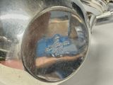 a reflection of a person in a tea pot