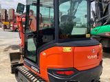 an orange and black construction vehicle parked in a parking lot