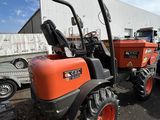 a tractor that is parked in front of a building